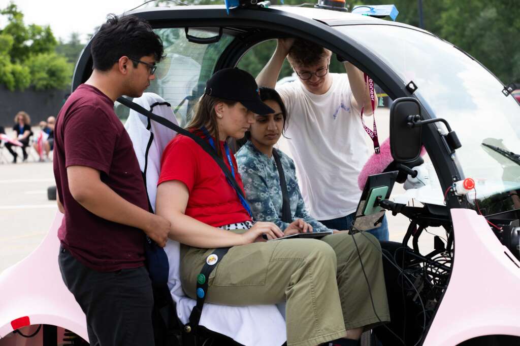 A team participating in the Self Drive challenge makes final adjustments to their vehicle during the 31st annual Intelligent Ground Vehicle Competition June 3 at Oakland University in Rochester, Michigan. Collegiate teams from local, out-of-state, and international institutions designed and competed autonomous vehicle systems in the four-day event.
